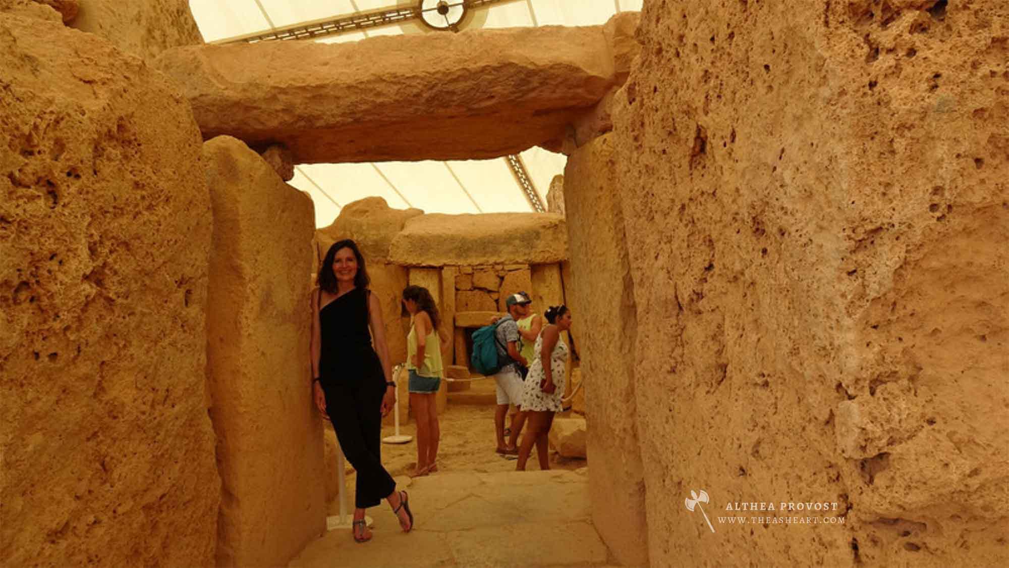 Starseed Malta Adventure 2019 — Althea Provost leaning on the doorway lintel of the Mnajdra megalithic temple, aligned to solstices, equinoxes, lunar cycles, and possibly Sirius.