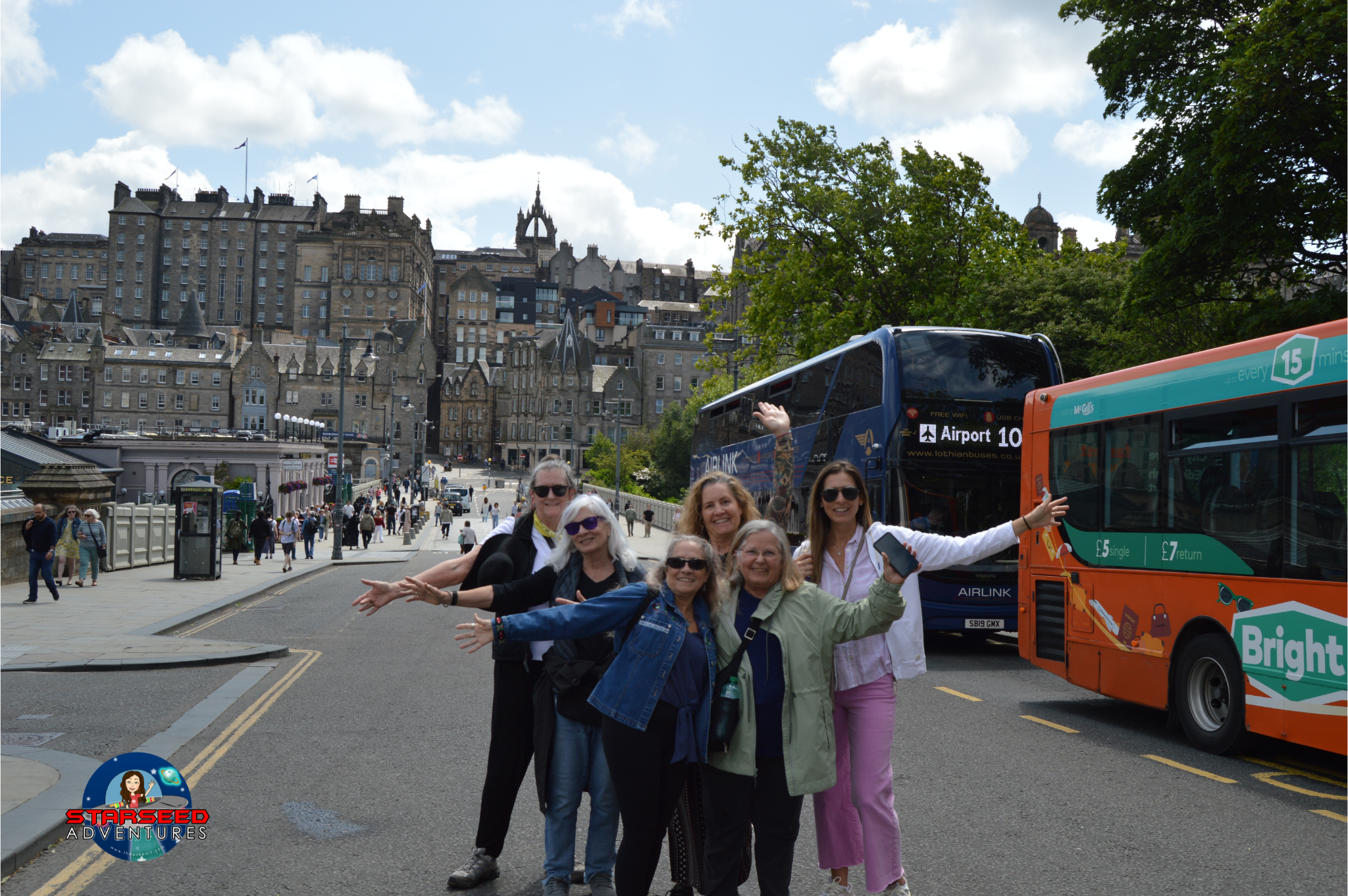 Starseed Scotland Adventure 2025 group standing in Old Town Edinburgh with historic buildings and city buses in background