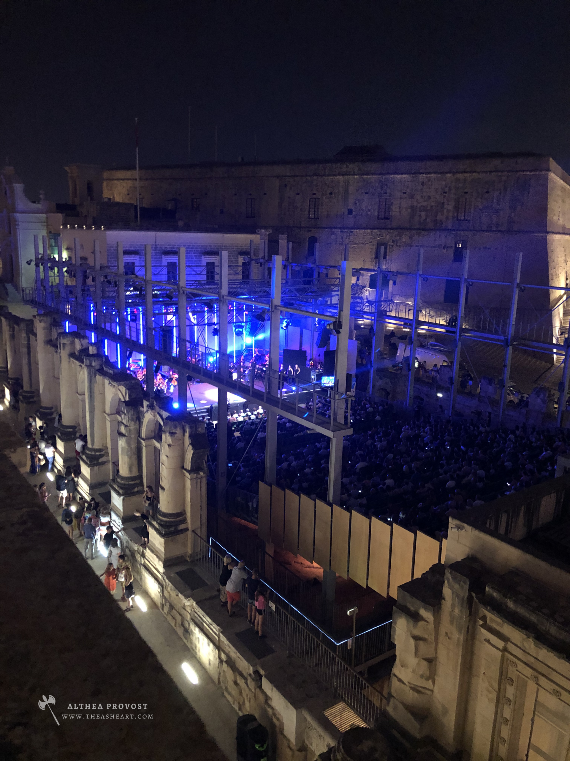 Stretched Beyond Human Proportion — Photographed by Althea Provost during the 2019 Starseed Malta Adventure, showing a nighttime concert held within the illuminated ruins of Malta’s former Royal Opera House.