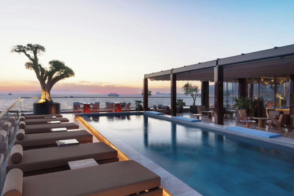 Marriott rooftop pool at sunset on the Starseed Türkiye Adventure with Althea Provost, overlooking the sea and city skyline.