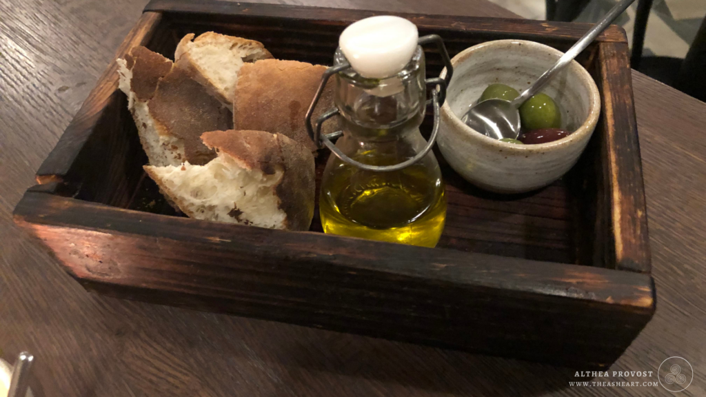 Starseed Malta Adventure 2019 Photo Gallery featuring rustic tray with olives, olive oil, and crusty bread.