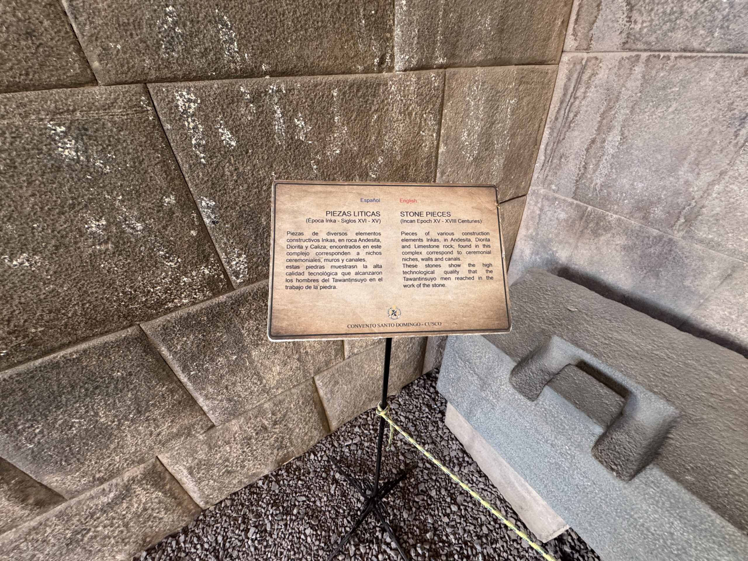 Stone Pieces Northeast Section of Coricancha - Thea's Heart Living Architecture: Interpretive sign and stone pieces in the northeast section of Coricancha, inside the Church of Santo Domingo in Cusco, Peru; the display explains the composition and function of Inca andesite, diorite, and limestone construction elements, photographed by Althea Provost during her Starseed Peru Adventure.