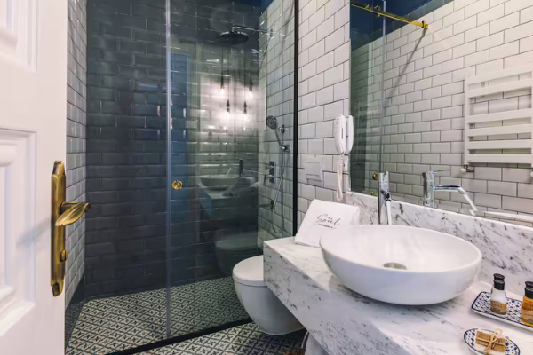 Modern bathroom at The Soul Hotel during the Starseed Türkiye Adventure with Althea Provost, featuring contemporary tilework and a glass shower.