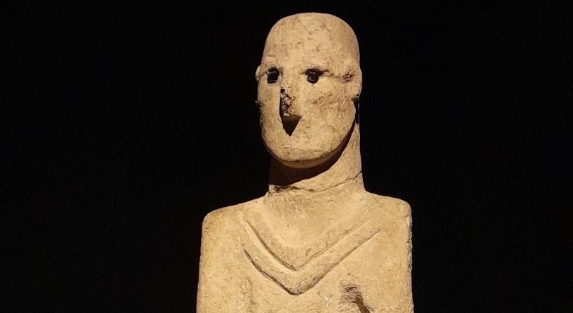 The Urfa Man statue displayed in the Şanlıurfa Archaeology Museum, carved from limestone with inset obsidian eyes.