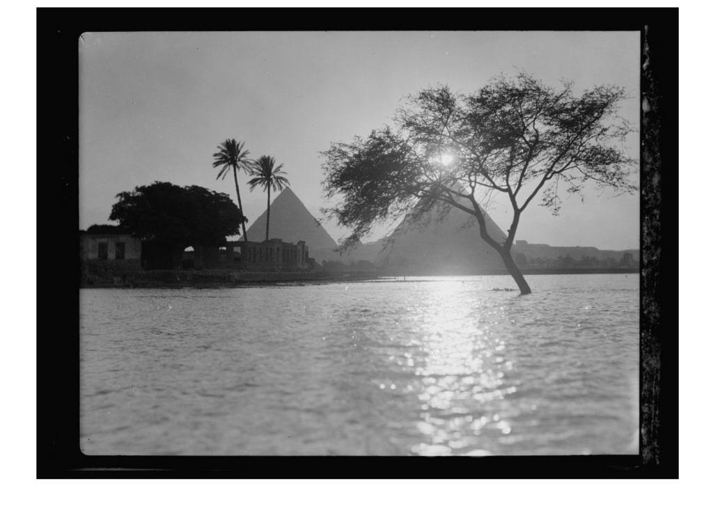 Giza pyramids silhouetted at sunset during Nile flood season, c. 1934
