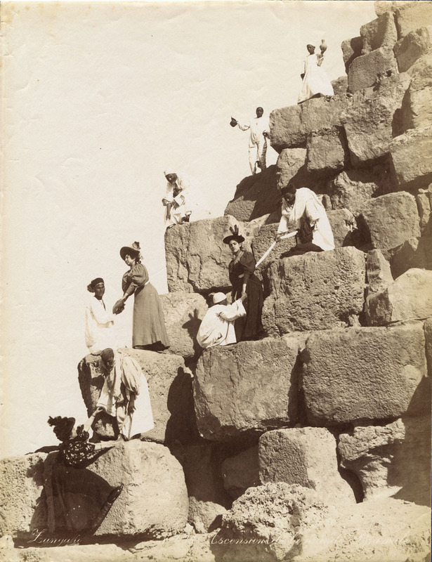 Group of tourists and guides climbing the limestone blocks of the Great Pyramid in Zangaki photograph No. 435, 1870–1885