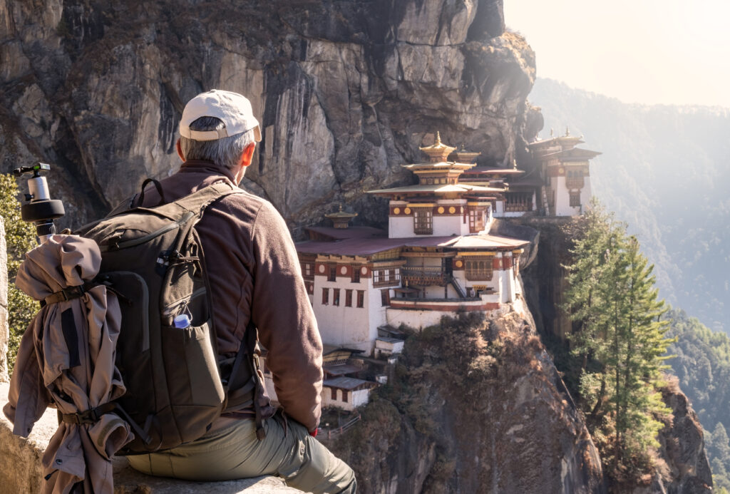 Starseed Bhutan Adventure with Althea Provost man overlooking Tiger’s Nest monastery from a distance.