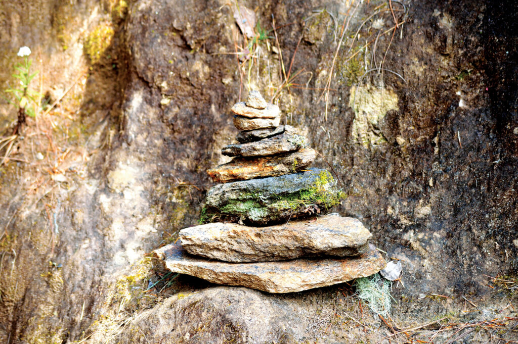 Starseed Bhutan Adventure with Althea Provost stacked rocks along the trail to Tiger’s Nest.