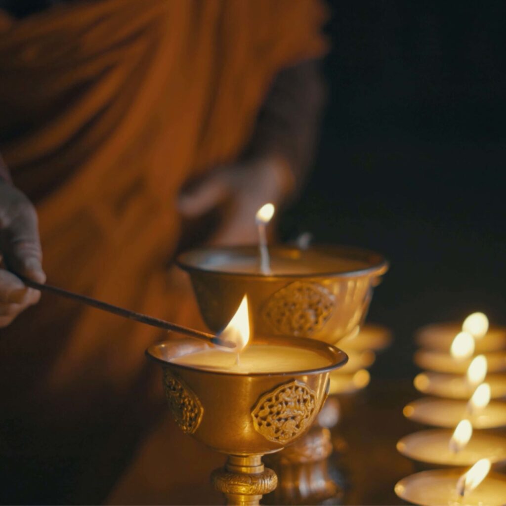 Starseed Bhutan Adventure with Althea Provost butter lamps being lit during a Bhutanese ceremony.