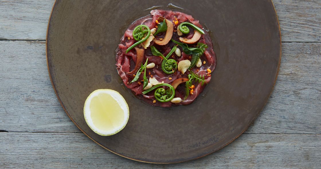 Starseed Bhutan Adventure Como Uma Paro Resort Bukhari Restaurant plated dish with thinly sliced meat with herbs