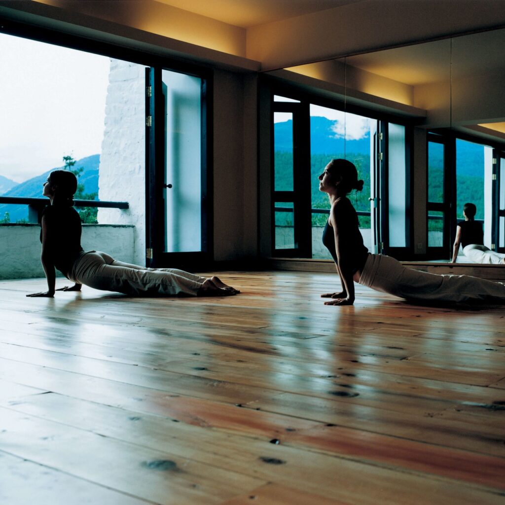 Starseed Bhutan Adventure with Althea Provost two women practicing yoga at COMO Uma Paro.