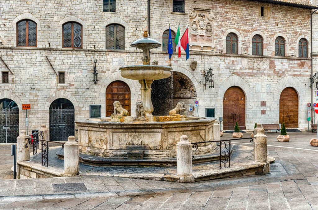 Saint Francis Walking Tour photo of the Fontana dei Tre Leoni in the central piazza of Assisi, Italy.